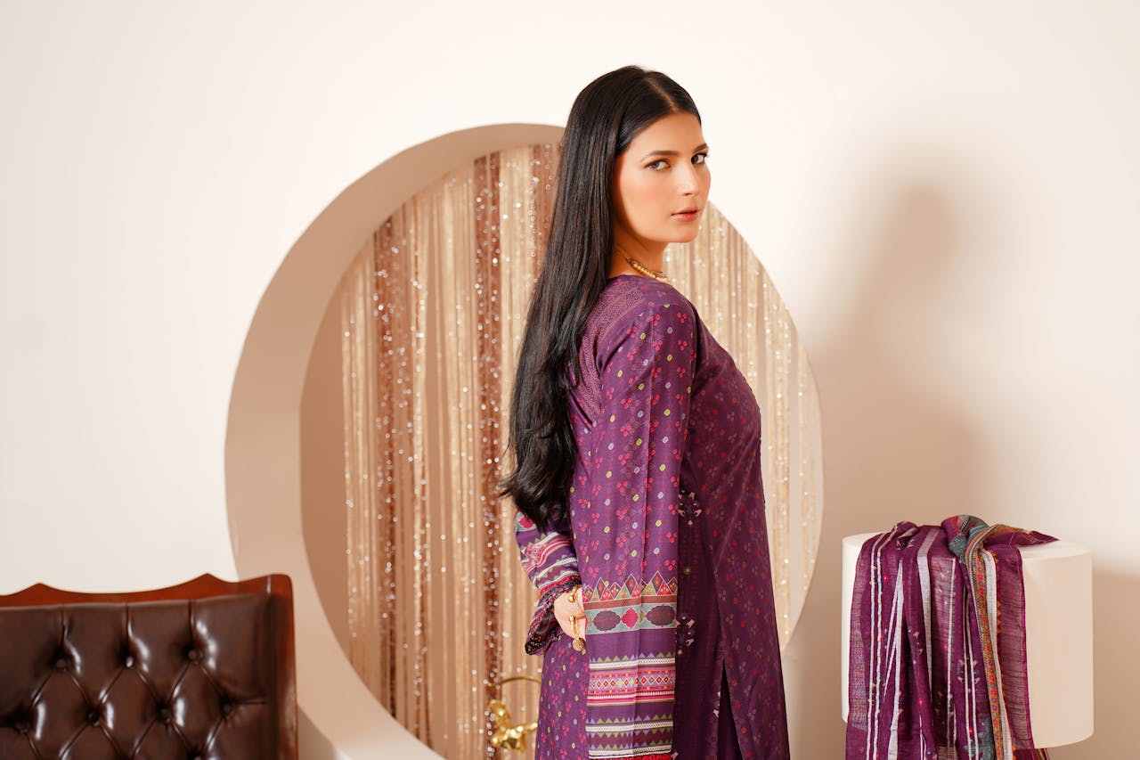 Portrait of a young woman in traditional Pakistani attire indoors in Lahore.